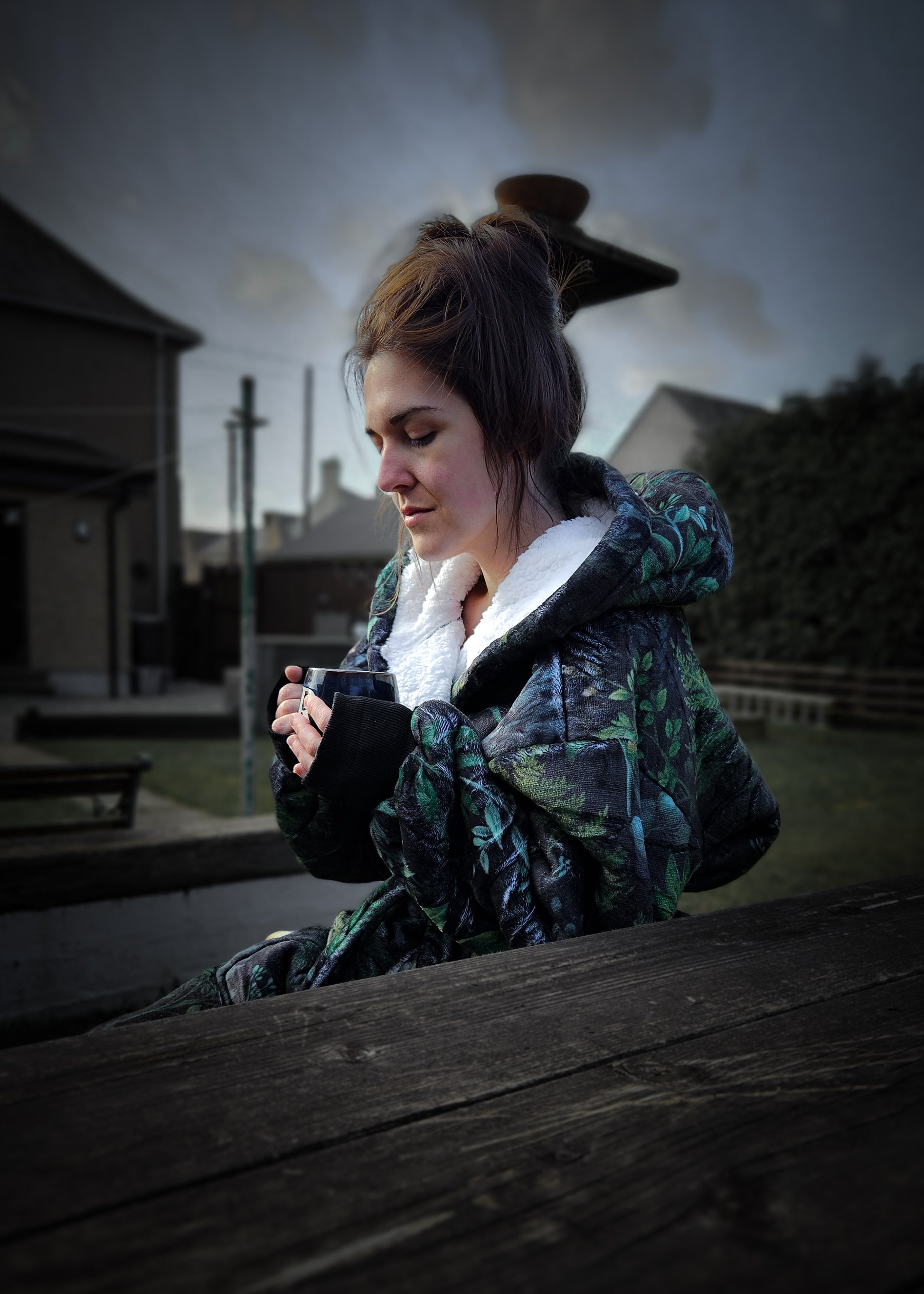 A woman sat on a bench wearing a Luxury Fern Fables Dressing Gown.